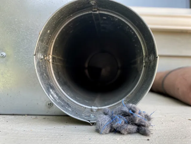 Cleveland Dryer Vent Cleaning technician using specialized equipment to clear severe dryer vent blockage in Cleveland